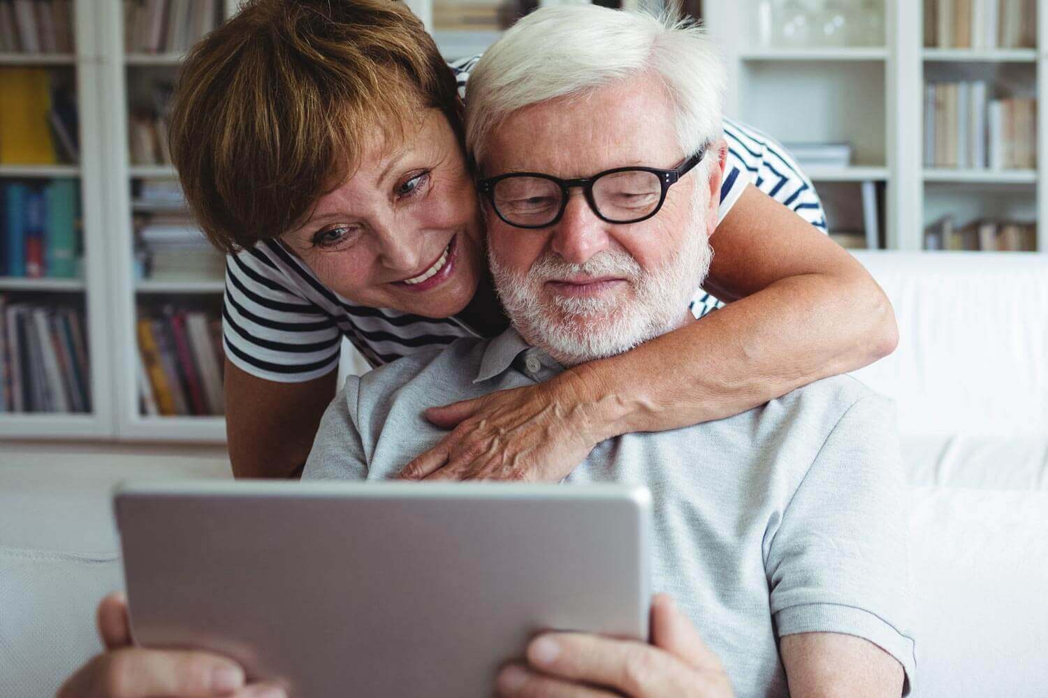 Older Woman and Man Looking a Tablet Computer going over Cataract Self Test results
